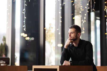 Businessman portrait at a modern cafe bar interior.の写真素材