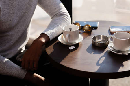 Friends in a restaurant talking smiling and drinking tea. Business colleagues having a meeting after work at a cafe bar. Abstract photo.の写真素材