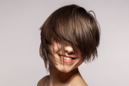 Beautiful girl fashion portrait. Smiling with wavy hair.の写真素材