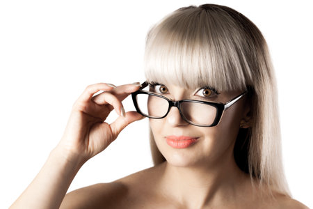 Portrait of a beautiful brunette girl with blond bangs fringe. Wearing glasses.の写真素材