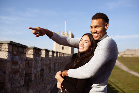 Multiracial couple posing on the walls of the Kale Fortress in Skopje North Macedonia. Man and woman in love.の写真素材