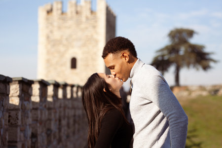 Multiracial couple posing on the walls of the Kale Fortress in Skopje North Macedonia. Man and woman in love.の写真素材