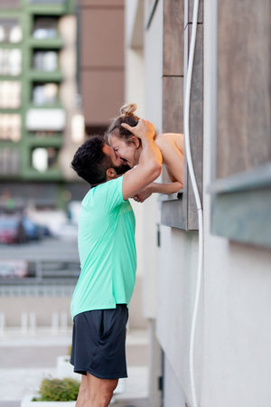Couple in love. Boy standing outdoors kissing a girl from within a window.の写真素材
