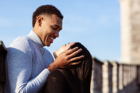 Multiracial couple on the walls of an old fortress. Man and woman in love.の写真素材