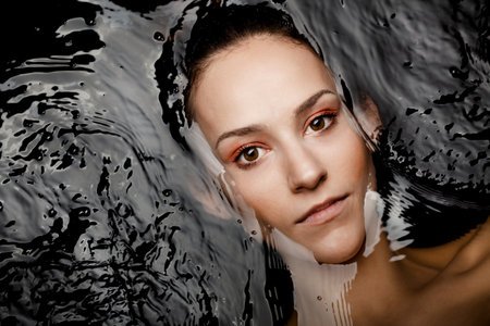Underwater beauty portrait of a beautiful caucasian girl. Looking at camera.の写真素材