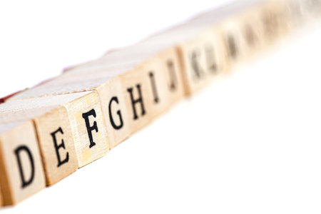 the alphabet on wooden stamps, focus on letter Fの写真素材