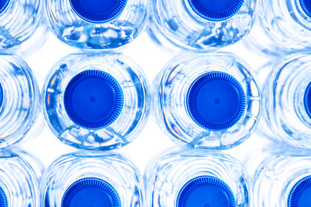 group of small plastic water bottles with blue cap.の写真素材