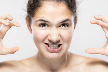 This engaging close-up captures a playful expression with expressive eyes and cheerful demeanor.