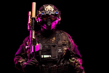 A heavily equipped tactical soldier in high-tech gear and armor posed under dramatic pink lighting. The futuristic style emphasizes advanced technology and military equipment.の写真素材