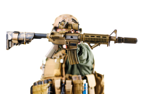 Soldier in tactical gear aiming an assault rifle in close focusの写真素材