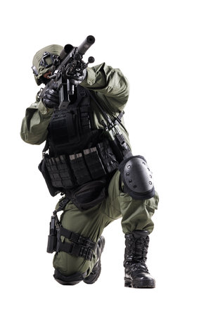 Tactical Operator in Action with Rifle Wearing Protective Gear During a Strategic Missionの写真素材