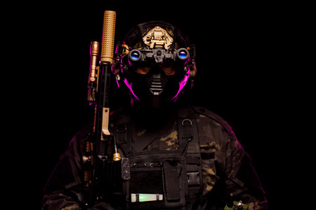 Advanced soldier equipped with tactical gear and night vision under dramatic lightingの写真素材