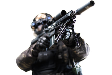 A Tactical Armed Soldier Posing with a Rifle Emphasizing Focus and Preparednessの写真素材