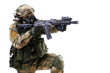 Tactical soldier in camouflage aiming rifle isolated on white backgroundの写真素材