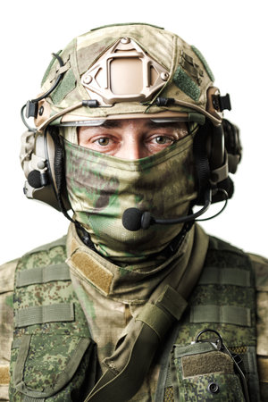 Close-Up Portrait of a Soldier in Tactical Gear with Headset and Camouflageの写真素材