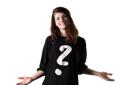 Portrait of a girl wearing black outfit with white question mark making questionable hand gestures....