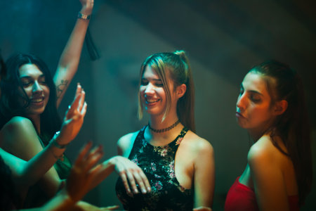 Group of friends enjoying a night out and dancing togetherの写真素材