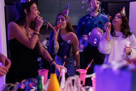 Group of friends celebrating a festive party with laughter and joyの写真素材