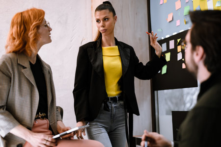 Team brainstorming session in a modern office with a focus on collaboration and creativity in progress during a bright morningの写真素材