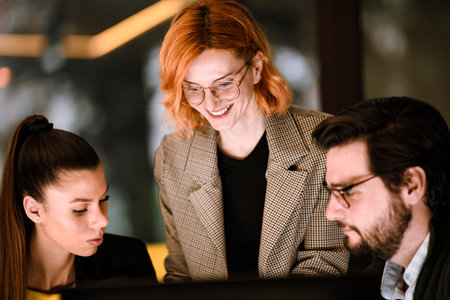 Team collaboration in a modern office during a project meeting with focus on creativity and teamwork among three colleaguesの写真素材