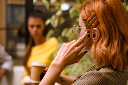 Engaging conversation in a cozy cafe setting during daylight with two people enjoying their time togetherの写真素材