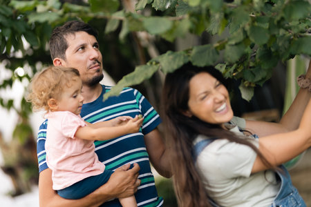 Happy Family Spending Time Outdoors in Nature with Their Child