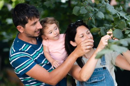 Family bonding while exploring nature and picking fruits, a joyful outdoor activity