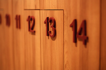 Wooden lockers numbered thirteen and fourteen within a contemporary storage area highlighting organizational design and functionalityの写真素材