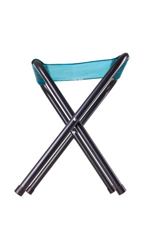 A metal folding chair with a blue fabric seat is shown in a crossed position. This design is ideal for easy storage and transport, perfect for outdoor activities or small spacesの写真素材
