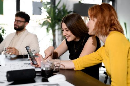 Business meeting in a modern office with team members collaborating on a project, discussing ideas, and sharing insights during the dayの写真素材