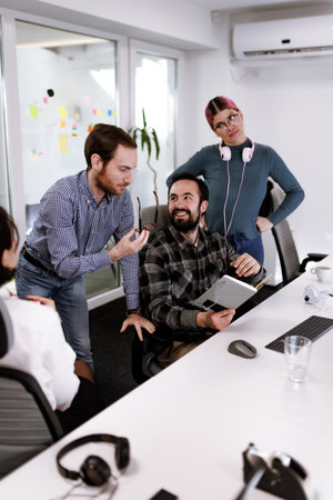 Business team collaborates in modern office space while discussing project ideas and sharing feedback during a productive meetingの写真素材