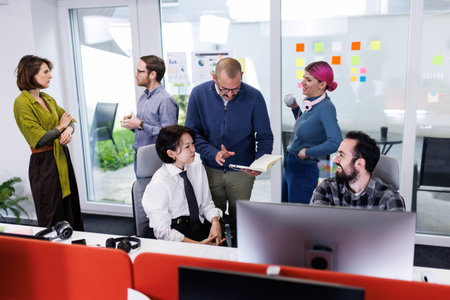 Collaboration among business professionals in a modern office setting during a brainstorming session to enhance productivity and teamworkの写真素材