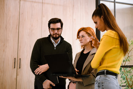 Group collaboration on a project in a modern office space with a focus on teamwork and technology...