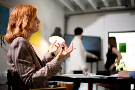 Business meeting in a modern office with professionals discussing ideas and strategies during a collaborative session in the late afternoonの写真素材