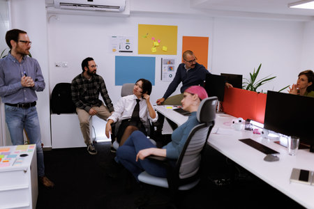 Business team meeting in a modern office, discussing project ideas and strategies while collaborating on tasks and initiatives during the workdayの写真素材