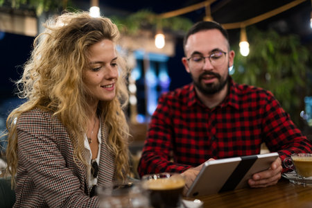 Young professionals having a casual meeting over coffee in a creative cafe setting, discussing ideas...
