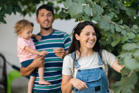 Family enjoying outdoor activities together in a garden setting surrounded by greenery
