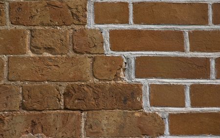 renovated old brickwall with old and new part