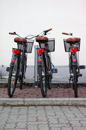 A row of rental bikes with plastic baskets 