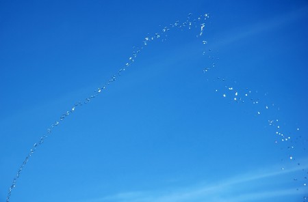 Water Drops isolated on blue skyの写真素材