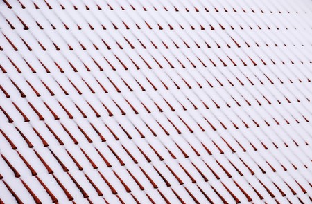 lot of snow on the roof at winterの写真素材