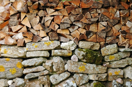 woodpile on stone wallの写真素材