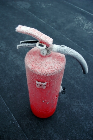 frosted fire extinguisher on floorの写真素材