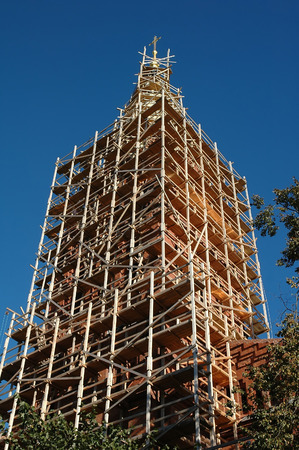 renovation of an church tower with golden crossの写真素材