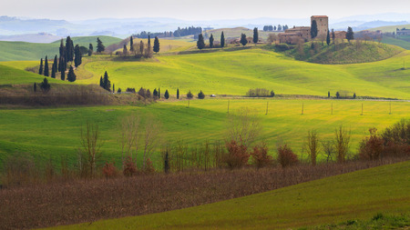 Val d'Orcia, March 2016: Landscape with hill, house and cypress, on March 2016 in Val d'Orcia, Tuscany, Italyのeditorial素材