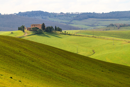 Val d'Orcia, March 2016: Landscape with hill, house and cypress, on March 2016 in Val d'Orcia, Tuscany, Italyのeditorial素材