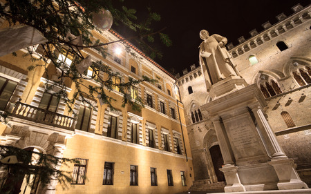 Siena, January 2016: Sallustio Bandini monument and  the main Gate of Monte dei Paschi Bank in Piazza Salimbeni with Christmas tree, on January 2016 in Siena, Tuscany, Italyのeditorial素材