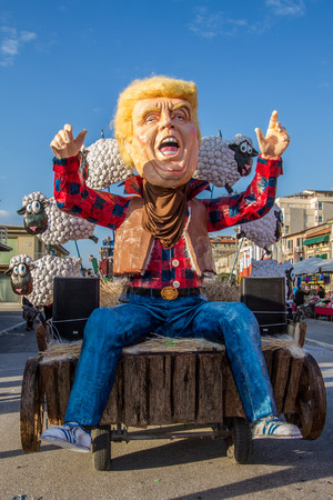 Viareggio, January 2018: Donald Trump caricature with flock of sheep in carnival parade of floats and masks, made of paper-pulp, on January 2018 in Viareggio, Tuscany, Italyのeditorial素材