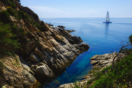 Yacht on seaside coast near beautiful lagoonの写真素材