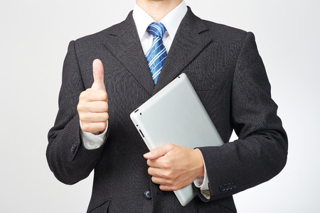 businessman holds tablet, no faceの写真素材